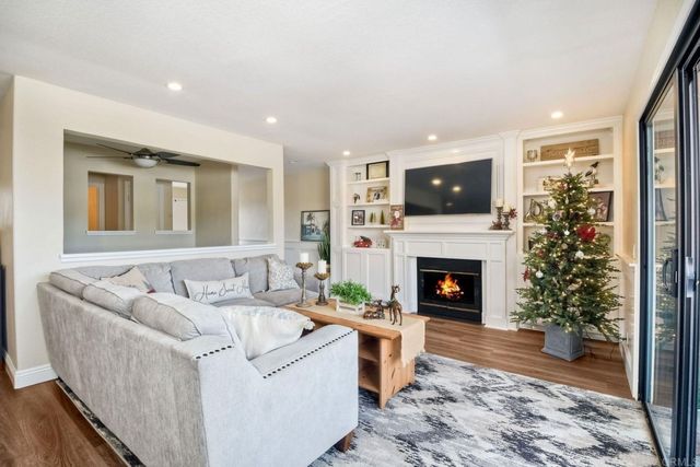 a living room with furniture a fireplace and a flat screen tv