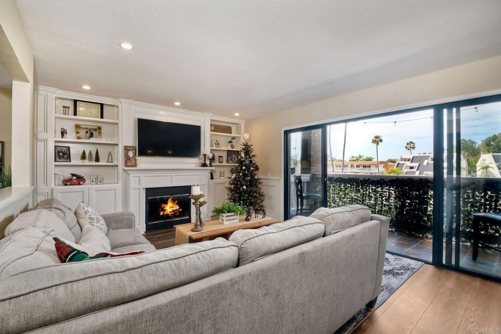 4705 Marina Drive, Unit 5 Carlsbad, CA 92008 - Photo 10 of 30 a living room with furniture a fireplace and a flat screen tv