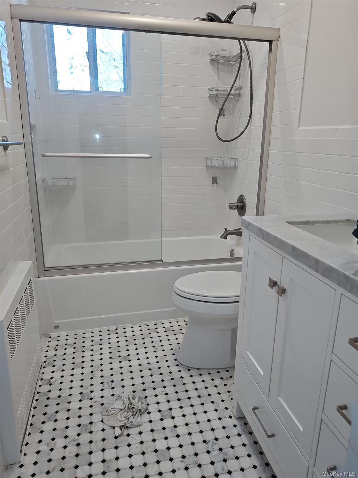 2354 North Wading River Road Wading River, NY 11792 - Photo 12 of 20 Full bath featuring vanity, bath / shower combo with glass door, tile walls, and radiator