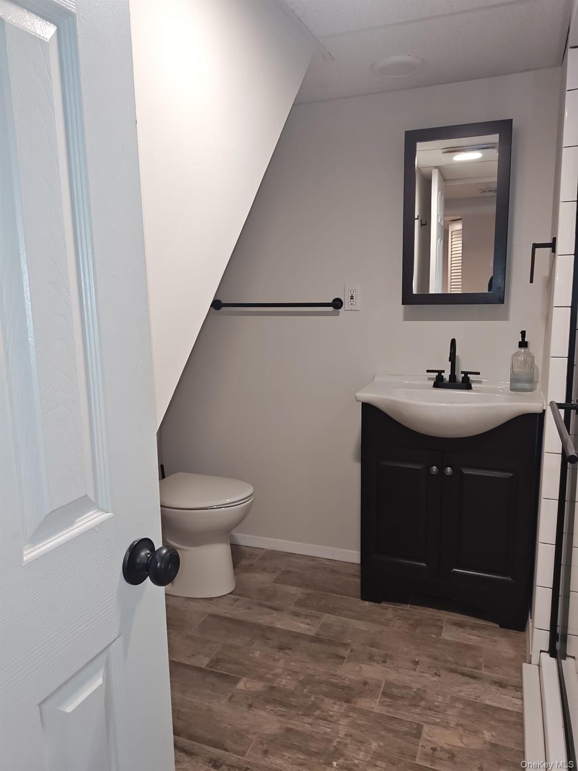 2354 North Wading River Road Wading River, NY 11792 - Photo 19 of 20 Half bath featuring vanity and dark wood finished floors