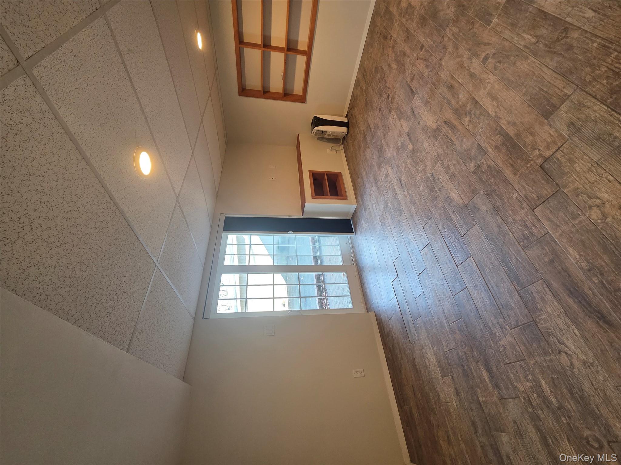 2354 North Wading River Road Wading River, NY 11792 - Photo 25 of 28 Basement with a paneled ceiling and dark wood finished floors