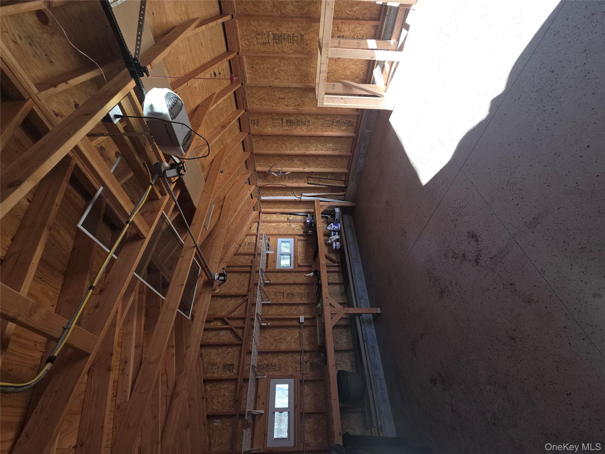 2354 North Wading River Road Wading River, NY 11792 - Photo 28 of 28 Misc room featuring a garage and vaulted ceiling