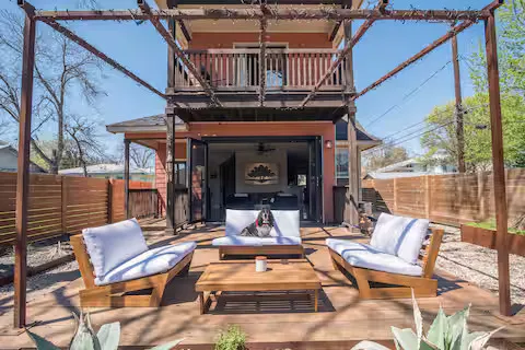 a view of a patio with a table chairs and a fireplace