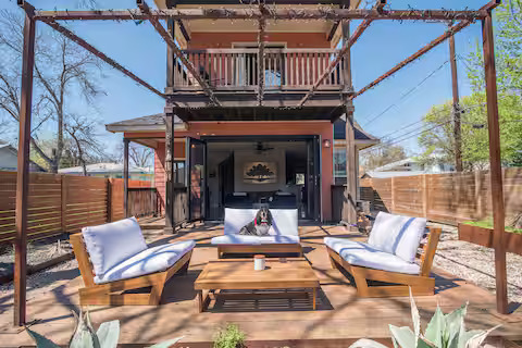 a view of a patio with a table chairs and a fireplace