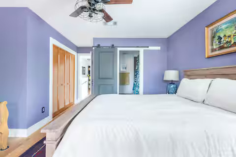 84 Anthony Street Austin, TX 78702 - Photo 12 of 17 a bedroom with a bed and a chandelier