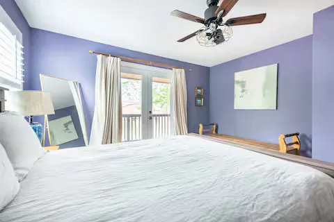 a bedroom with a large bed and a large window