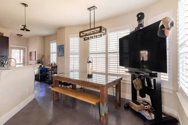 a living room with furniture gym equipment and a flat screen tv