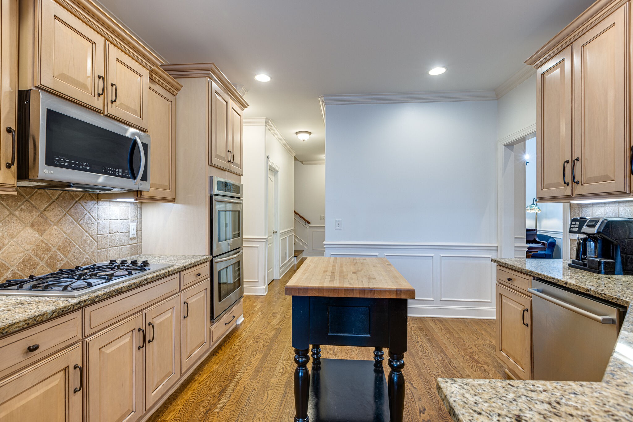 1213 White Rock Road Spring Hill, TN 37174 - Photo 18 of 50 a kitchen with stainless steel appliances kitchen island granite countertop a stove a sink and a microwave