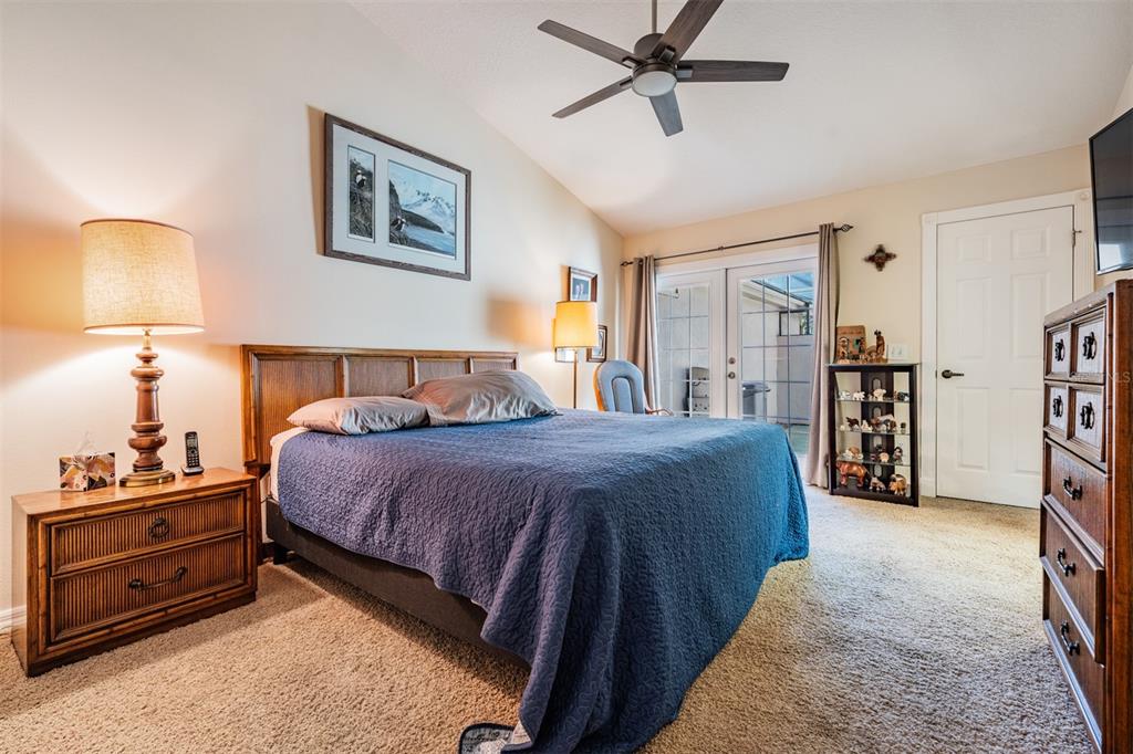 17569 Fairmeadow Drive Tampa, FL 33647 - Photo 13 of 60 a bedroom with a bed and a lamp on dresser