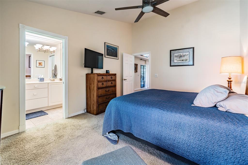 17569 Fairmeadow Drive Tampa, FL 33647 - Photo 14 of 60 a bedroom with a bed and a flat screen tv