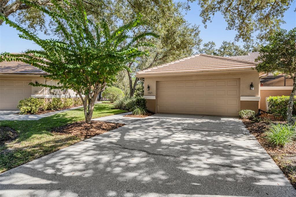 17569 Fairmeadow Drive Tampa, FL 33647 - Photo 33 of 60 a front view of a house with a garden