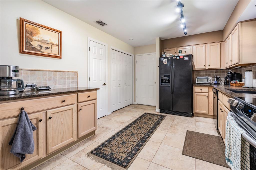17569 Fairmeadow Drive Tampa, FL 33647 - Photo 5 of 60 a kitchen with stainless steel appliances granite countertop a refrigerator stove and sink
