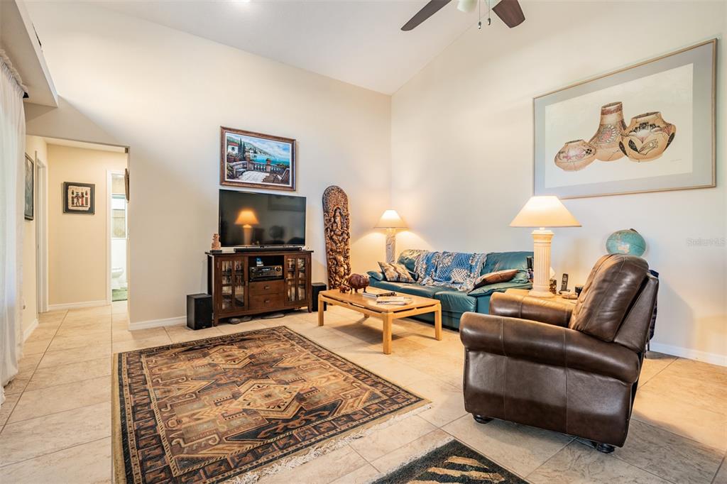 17569 Fairmeadow Drive Tampa, FL 33647 - Photo 10 of 60 a living room with furniture and a flat screen tv