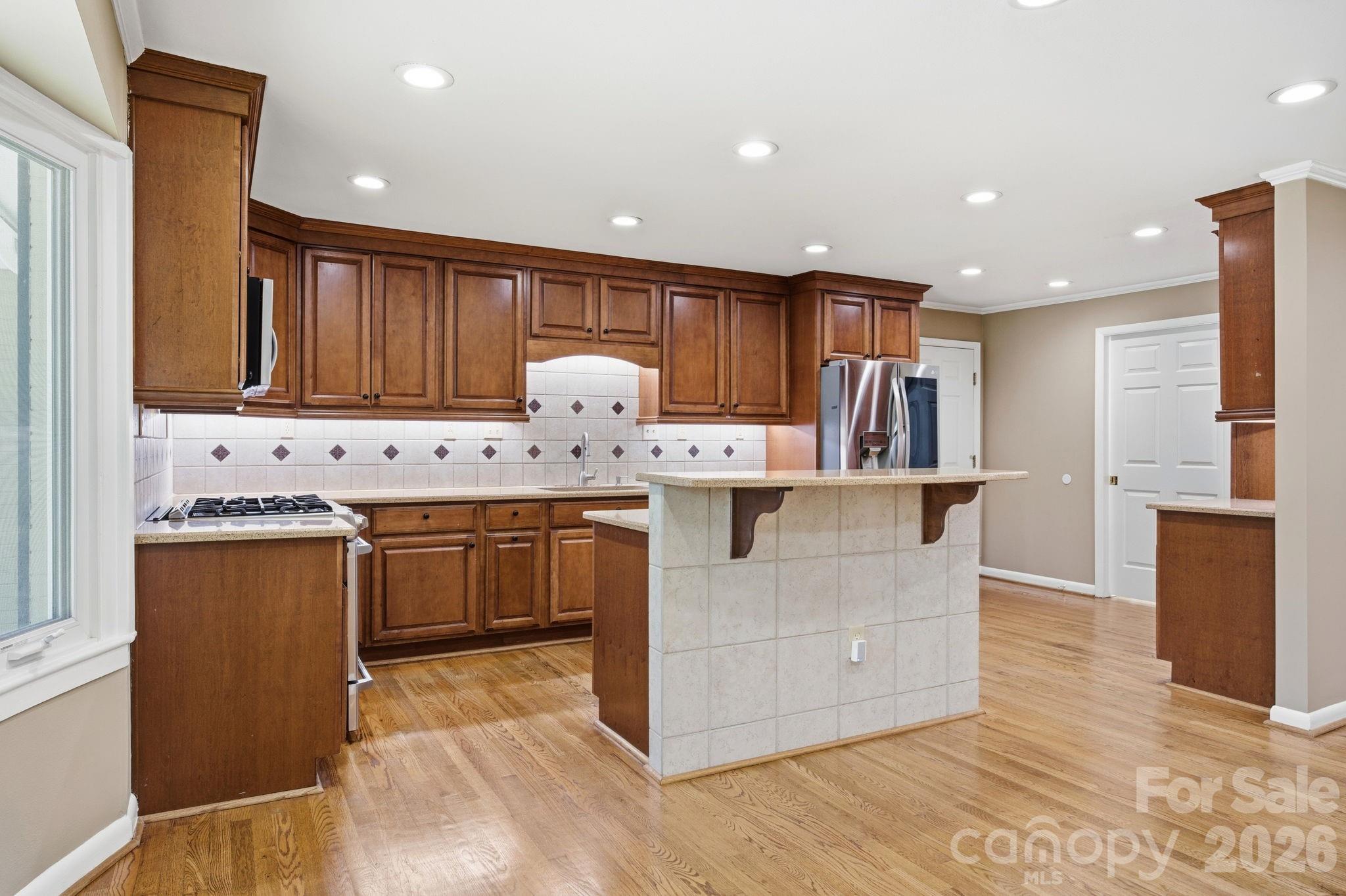 225 Stonewall Road Salisbury, NC 28144 - Photo 21 of 48 a kitchen with stainless steel appliances granite countertop a stove a sink and a refrigerator