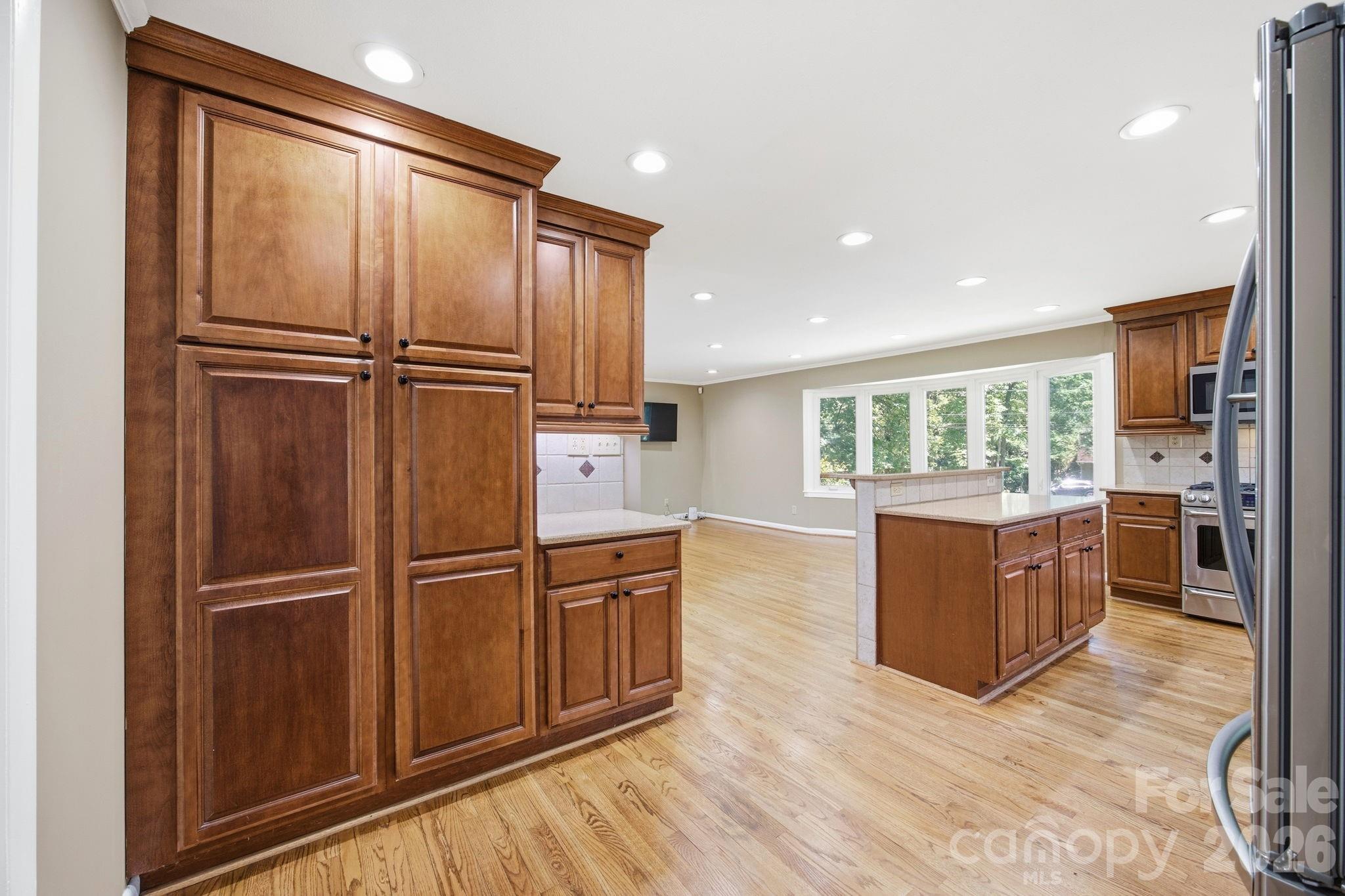 225 Stonewall Road Salisbury, NC 28144 - Photo 22 of 48 a kitchen with stainless steel appliances granite countertop a refrigerator and wooden cabinets