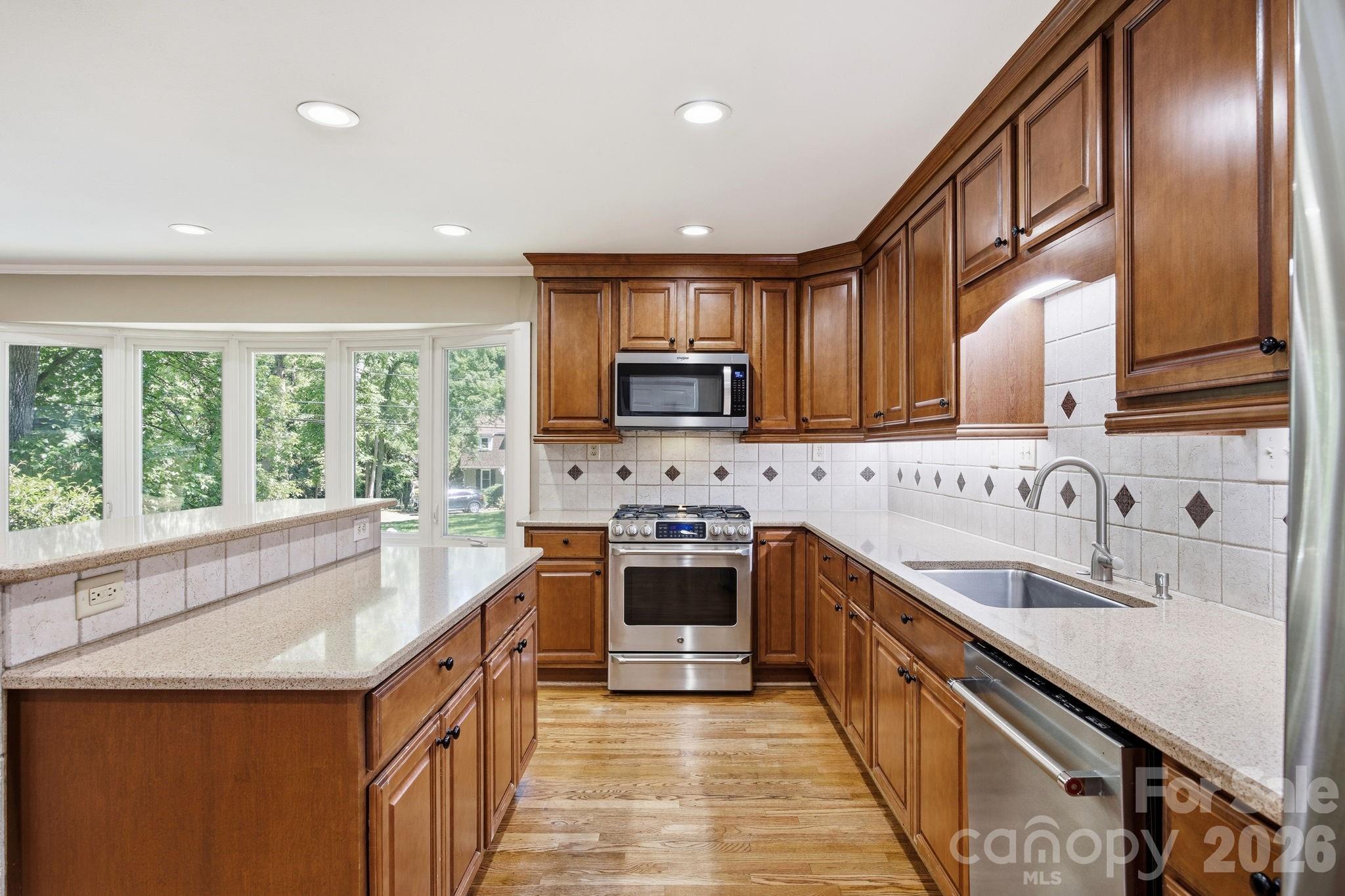 225 Stonewall Road Salisbury, NC 28144 - Photo 23 of 48 a kitchen with stainless steel appliances granite countertop a sink and a stove top oven