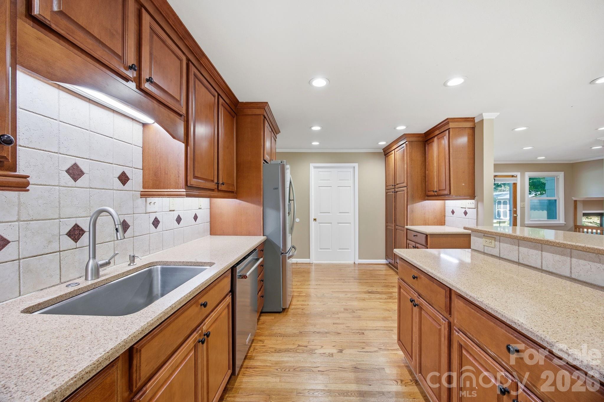 225 Stonewall Road Salisbury, NC 28144 - Photo 24 of 48 a kitchen with stainless steel appliances granite countertop a sink and dishwasher a stove with wooden cabinets