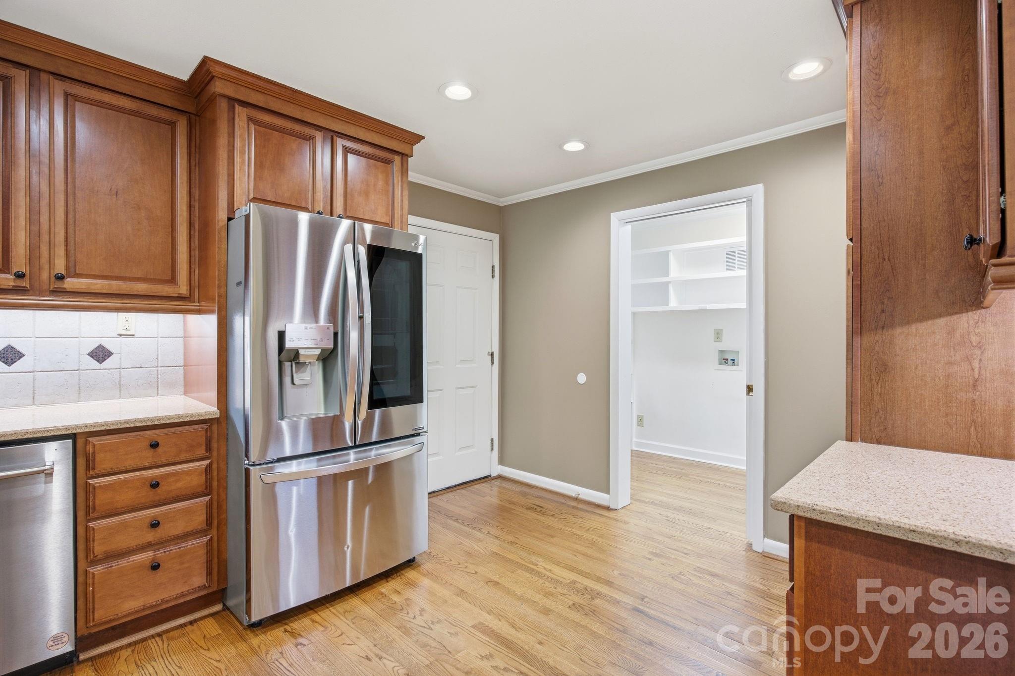 225 Stonewall Road Salisbury, NC 28144 - Photo 25 of 48 a kitchen with kitchen island wooden cabinets and stainless steel appliances