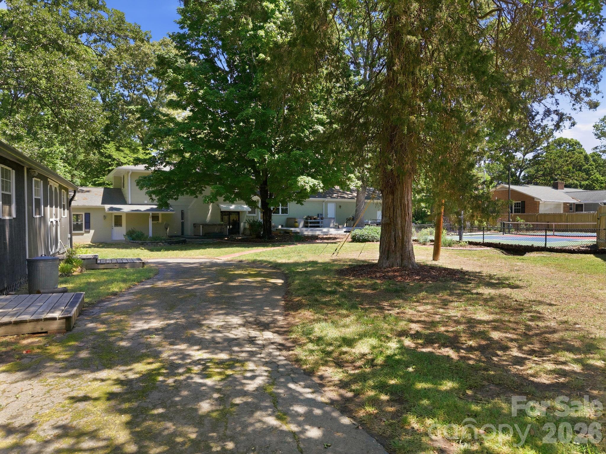 225 Stonewall Road Salisbury, NC 28144 - Photo 46 of 48 a view of a yard with a house and large trees