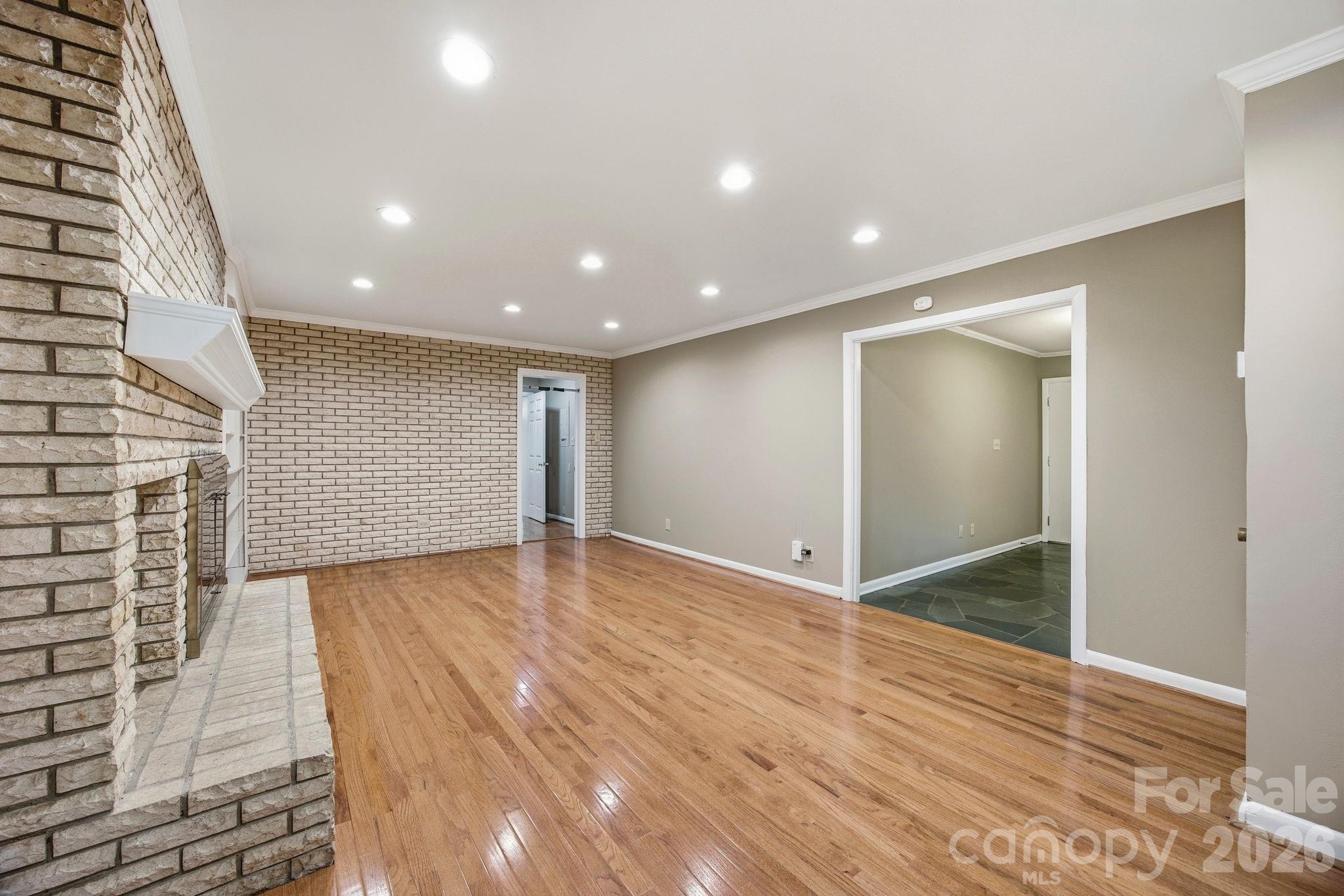 225 Stonewall Road Salisbury, NC 28144 - Photo 10 of 48 a view of an empty room with wooden floor and a bathroom