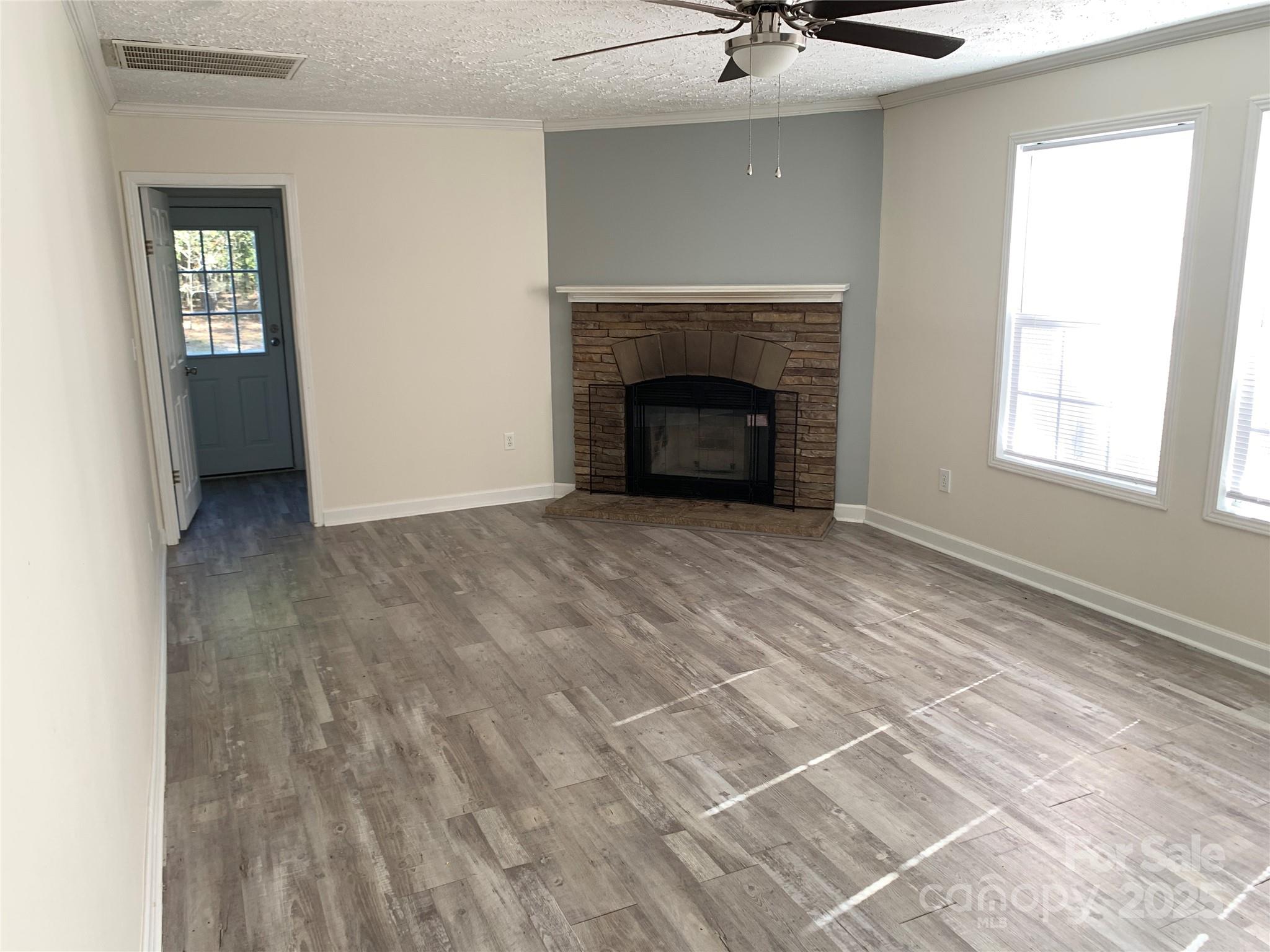 1773 State Rd S-28-32 Kershaw, SC 29067 - Photo 13 of 28 a view of an empty room with a fireplace and a window