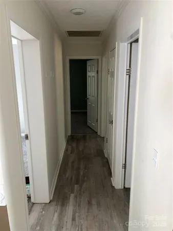 a view of a hallway with wooden floor