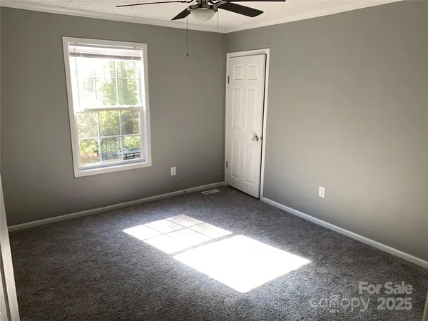 a view of an empty room and a window