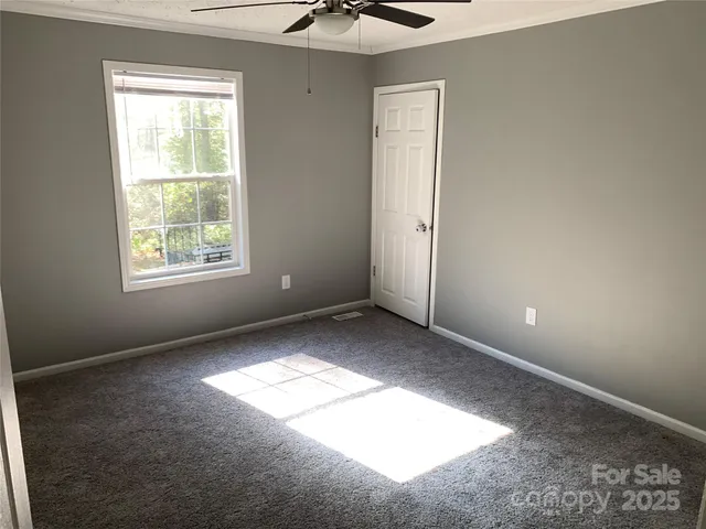 a view of an empty room and a window