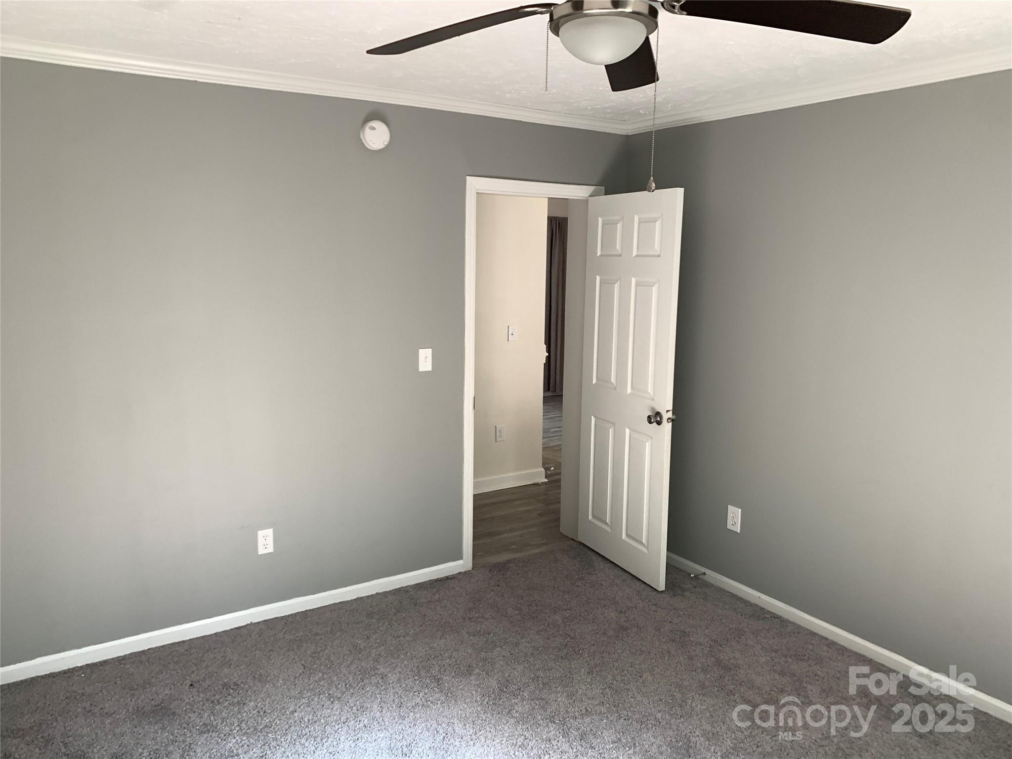 1773 State Rd S-28-32 Kershaw, SC 29067 - Photo 23 of 28 an empty room with a ceiling fan and carpet