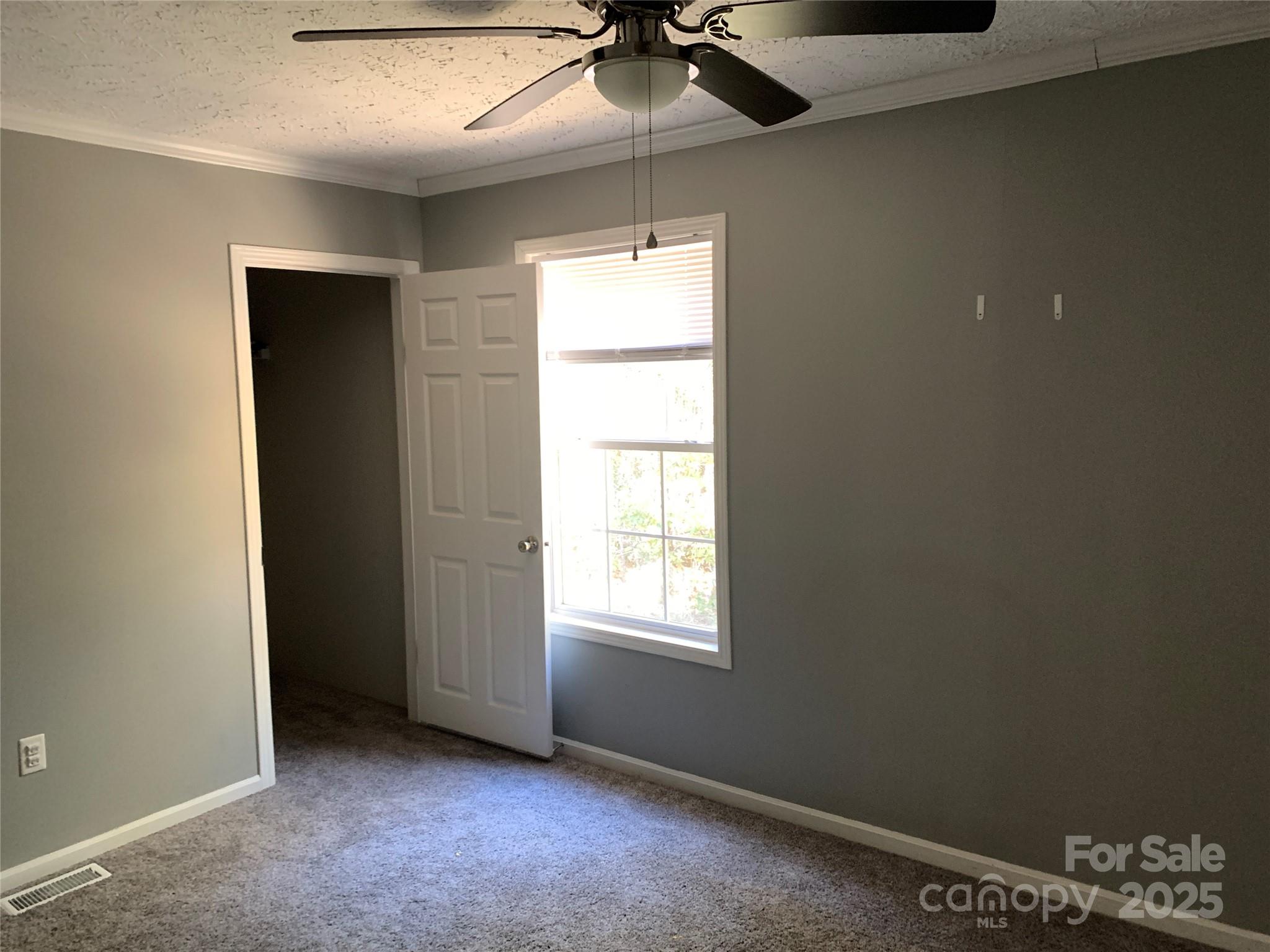 1773 State Rd S-28-32 Kershaw, SC 29067 - Photo 24 of 28 an empty room with a window and a ceiling fan