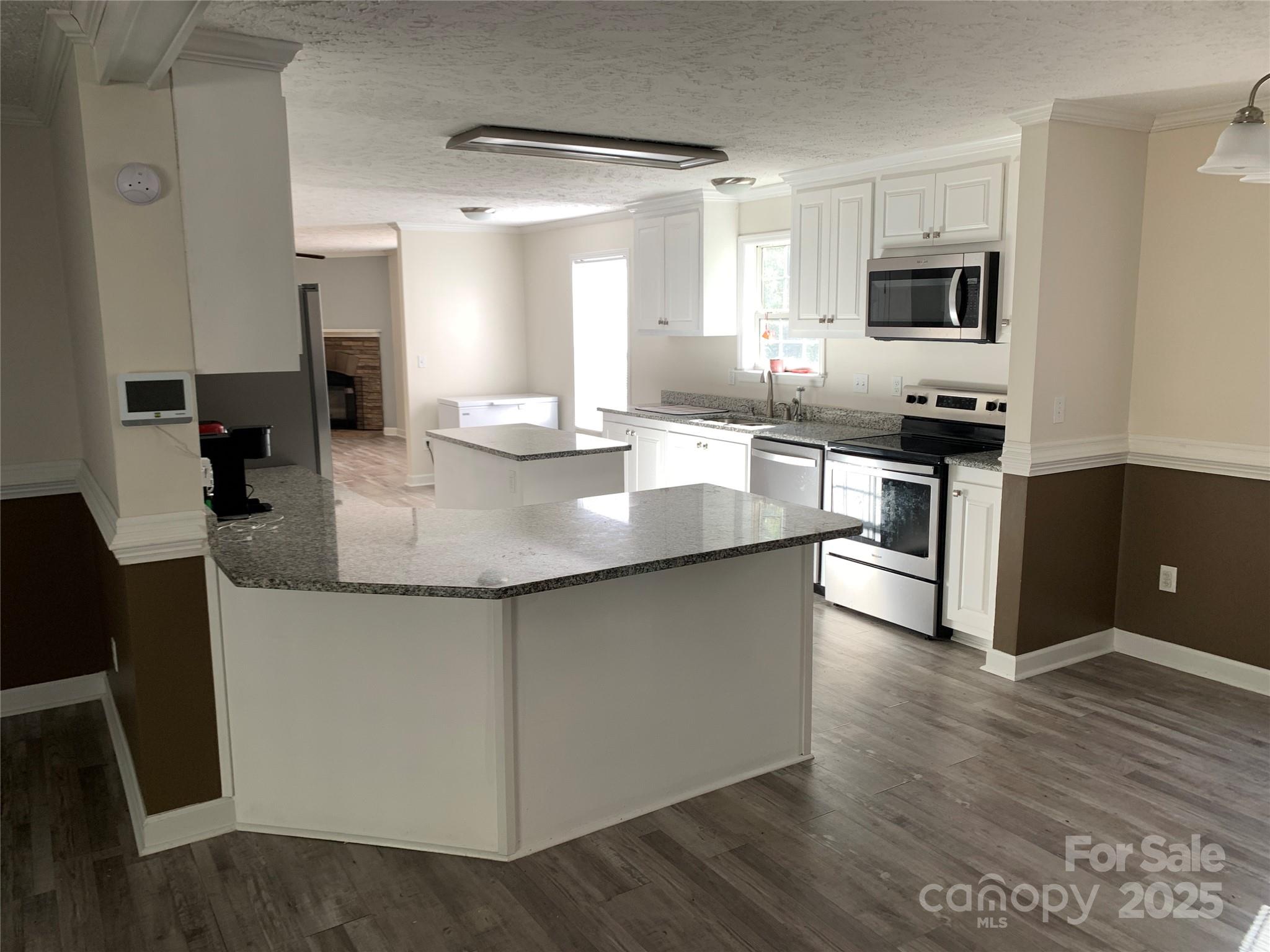 1773 State Rd S-28-32 Kershaw, SC 29067 - Photo 5 of 28 a large kitchen with granite countertop a stove and a sink