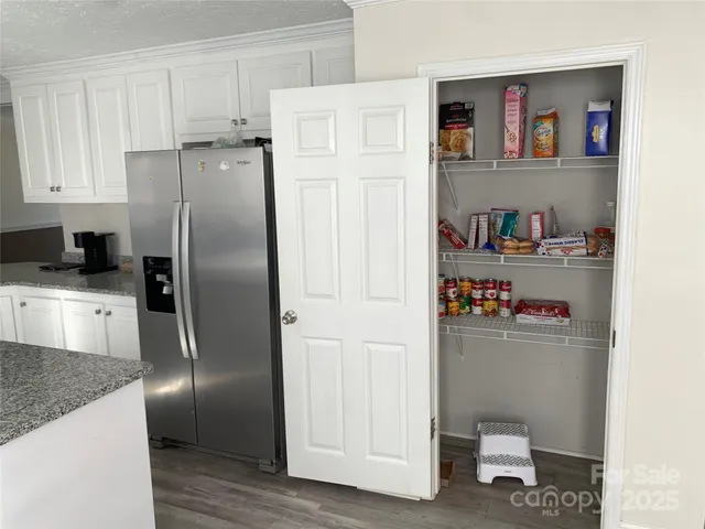 a kitchen with stainless steel appliances granite countertop a refrigerator and a sink