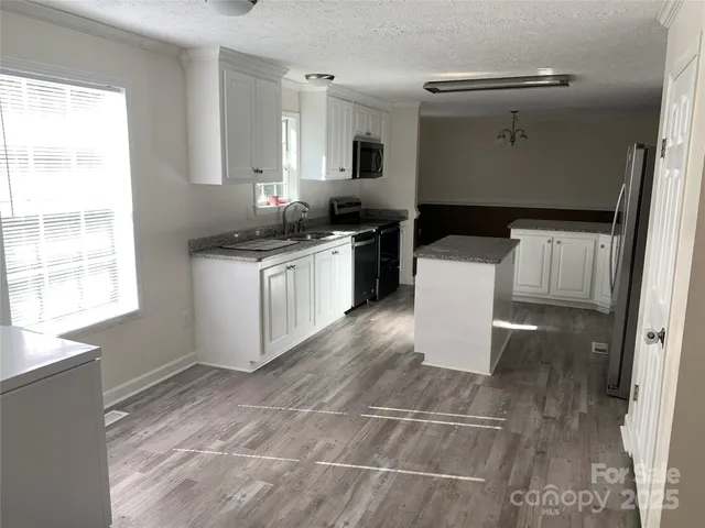 a kitchen with a sink cabinets and window