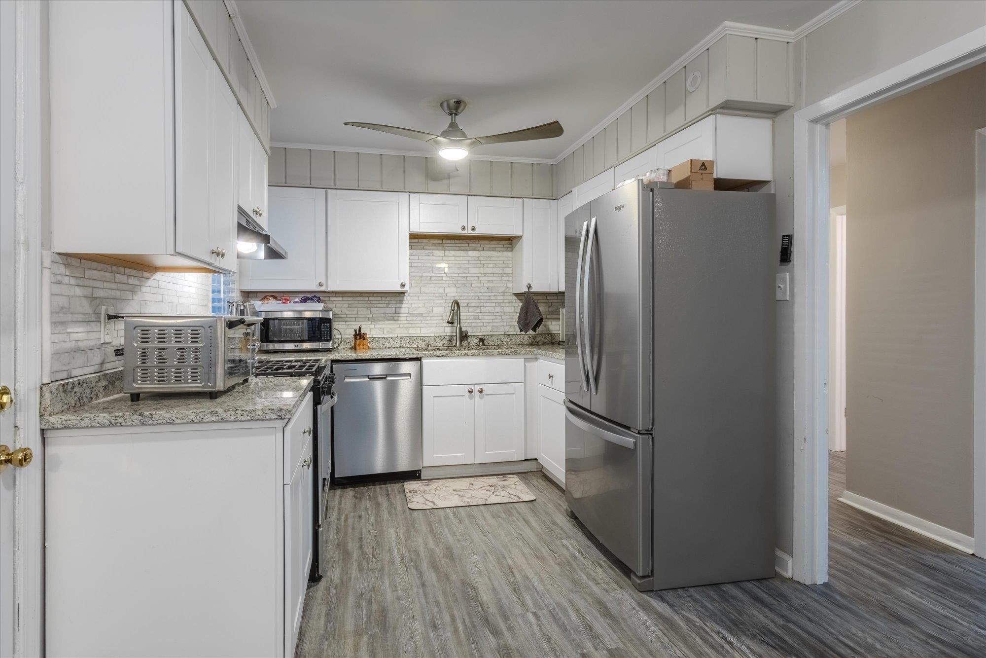 1493 Raymore Road Memphis, TN 38117 - Photo 13 of 27 a kitchen with a refrigerator a sink and wooden cabinets