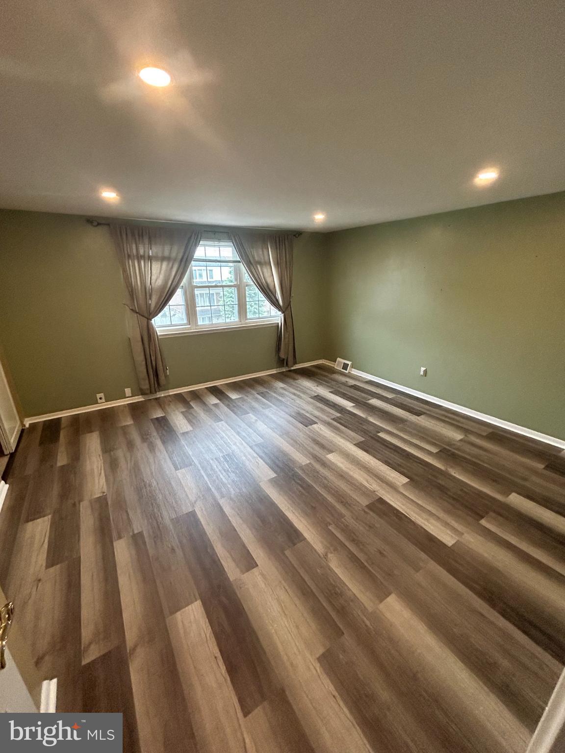 10830 Perrin Road Philadelphia, PA 19154 - Photo 13 of 25 an empty room with wooden floor and windows