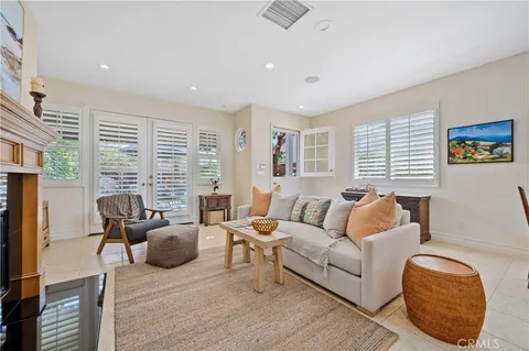 a living room with furniture fireplace and window