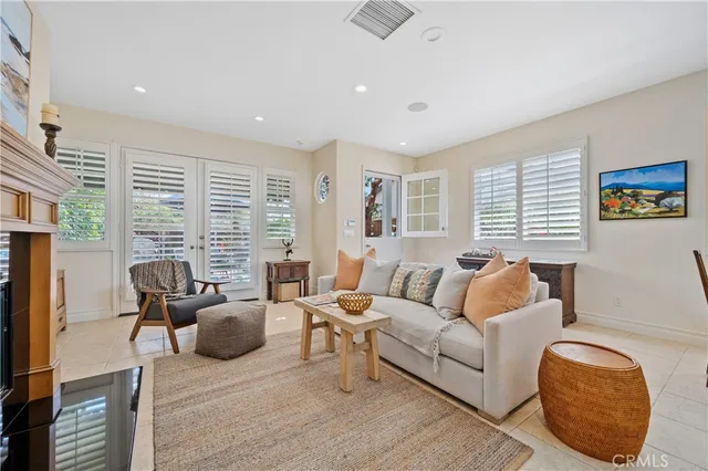 a living room with furniture fireplace and window