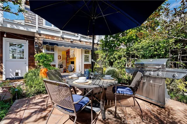 a living room with furniture a fireplace and a kitchen view