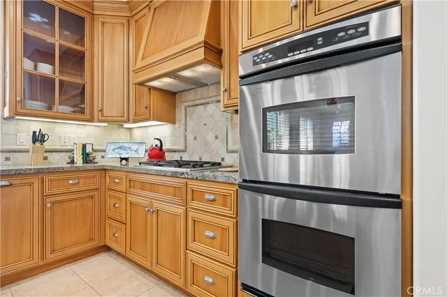 a kitchen with granite countertop stainless steel appliances and cabinets