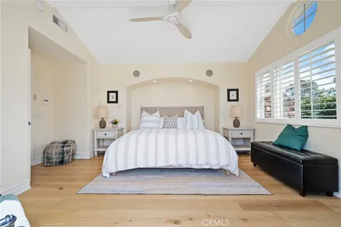 a spacious bedroom with a bed and a couch