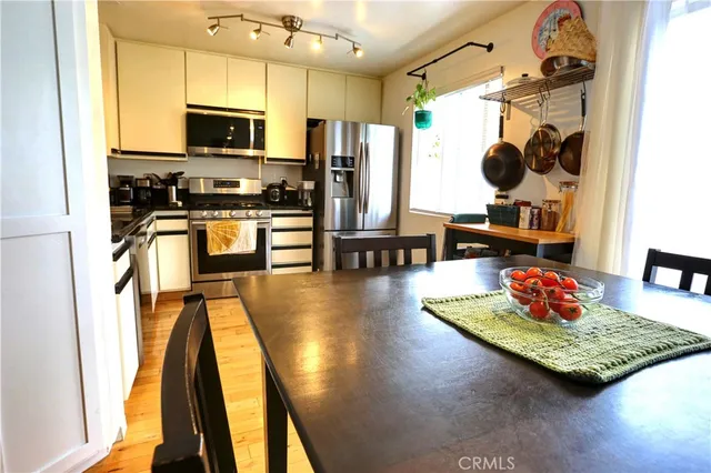 a view of a dining room with furniture and a kitchen