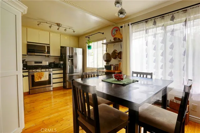 a kitchen with stainless steel appliances granite countertop a sink refrigerator and microwave