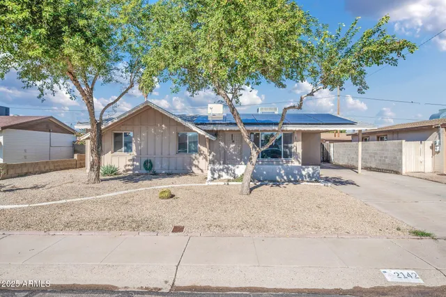 a house with a tree in front of it