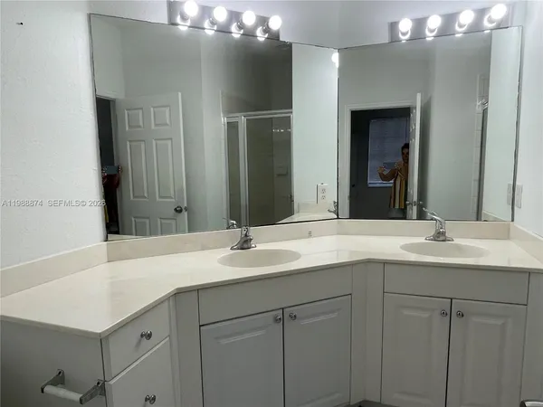 a bathroom with a sink and a mirror