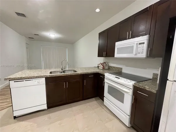 a kitchen with a sink and a stove top oven