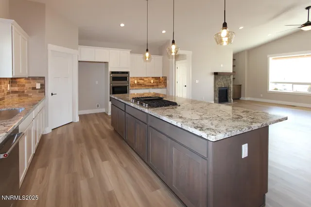 a kitchen with stainless steel appliances granite countertop a sink stove and a refrigerator