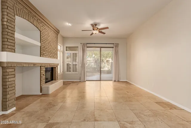 a view of an empty room with a fireplace