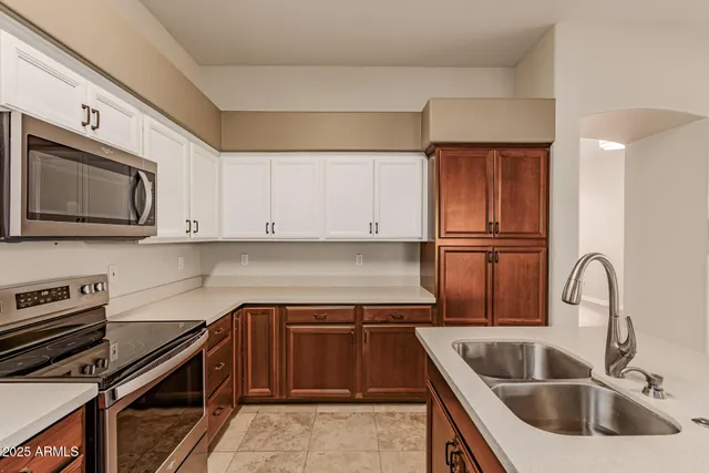 a kitchen with granite countertop a sink and a stove top oven