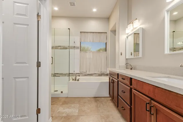 a bathroom with a tub sink and mirror
