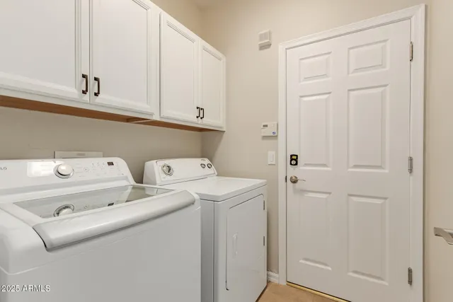 a view of storage and utility room with washer and dryer